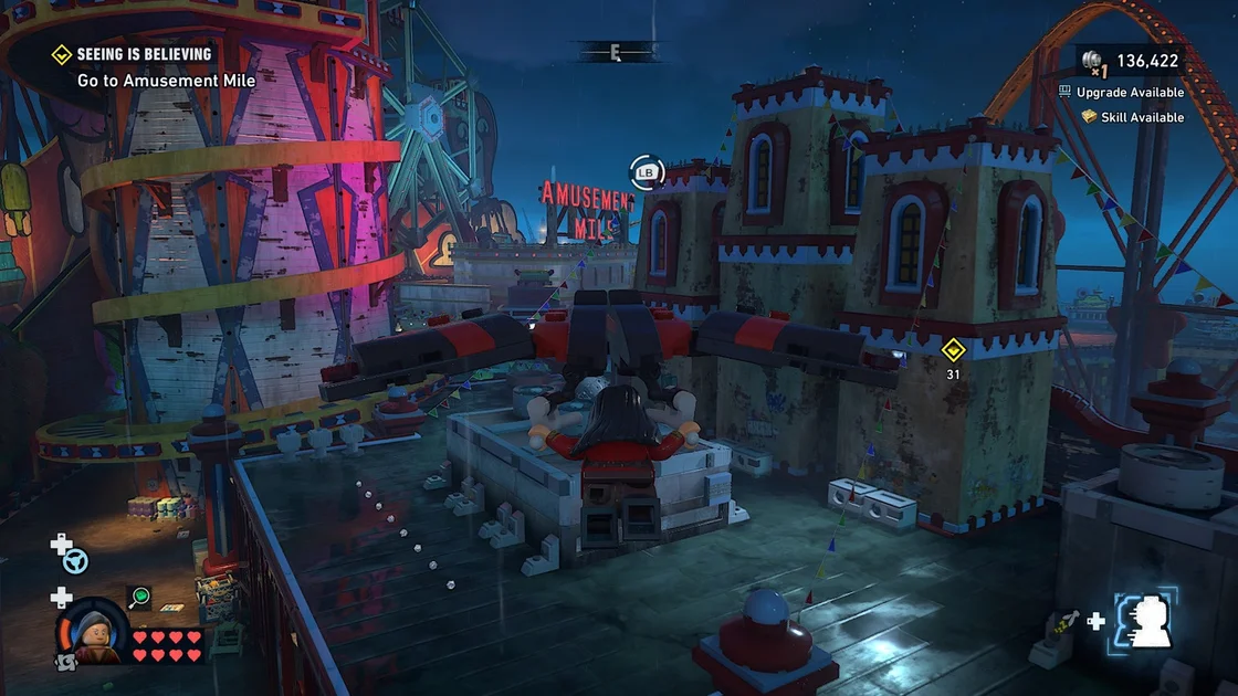 Lego Batman: Legacy of the Dark Knight screenshot showing traversal over a theme park at night