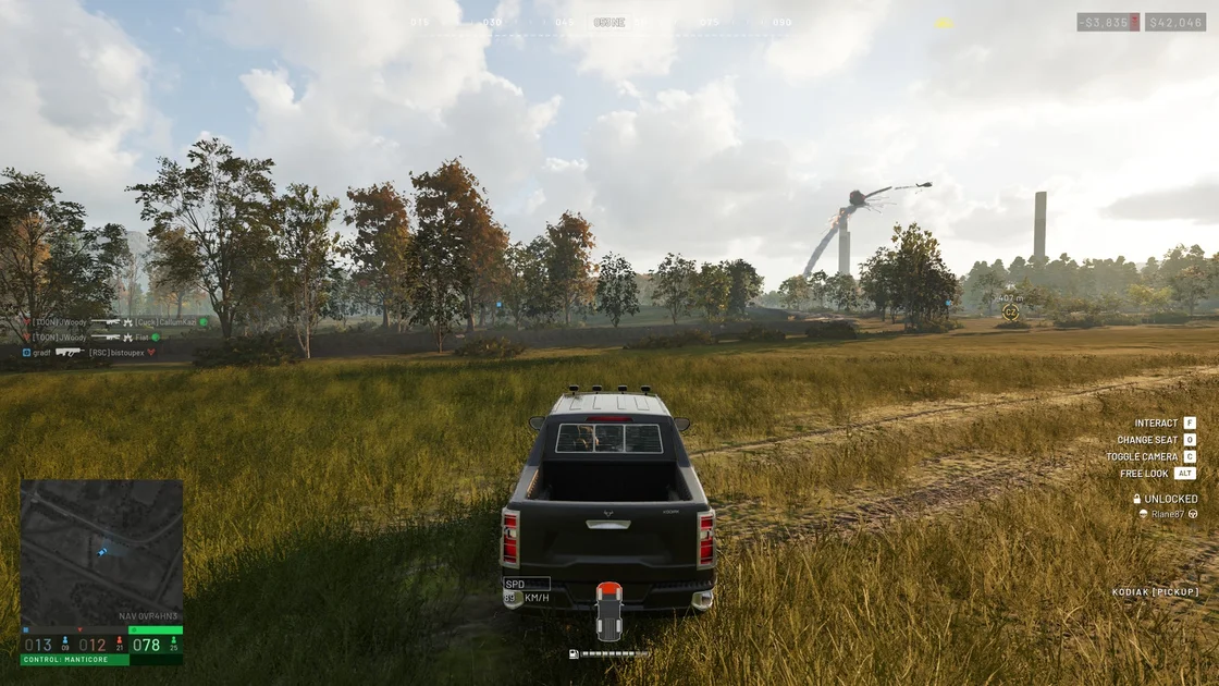 A Screenshot of Wardogs, showing the player driving a vehicle through a field as a helicopter explodes in the sky, trailing smoke.
