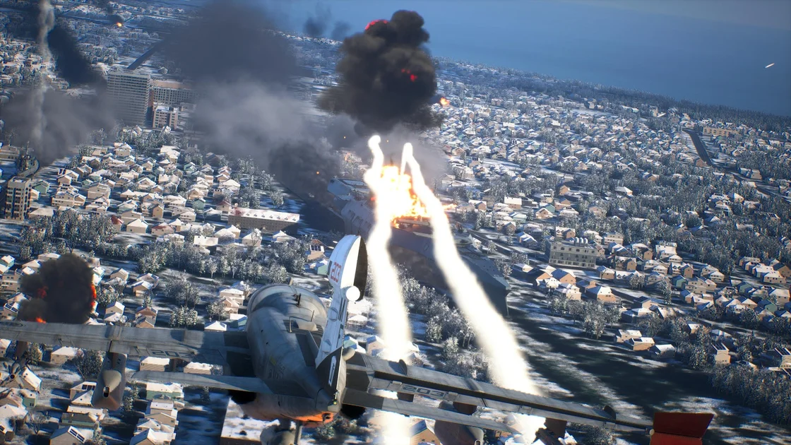 Ace Combat 8: Wings of Theve screenshot showing a bomber in the foreground and two air-to-ground missiles hitting a huge land battleship. Thick smoke billows from its damaged hull.